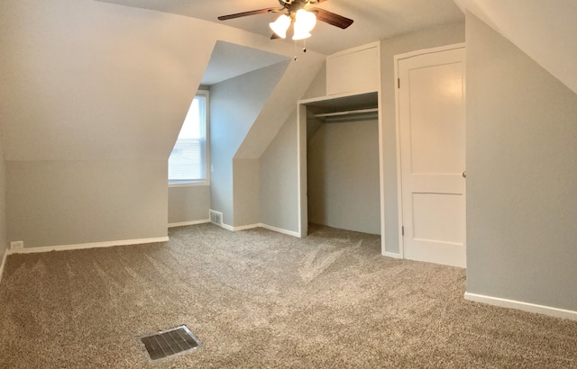 additional living space featuring ceiling fan, light colored carpet, and vaulted ceiling