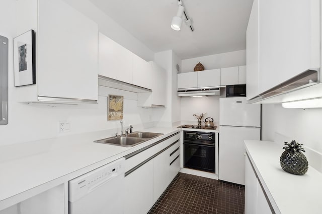 kitchen with dark tile patterned floors, black appliances, white cabinetry, rail lighting, and sink