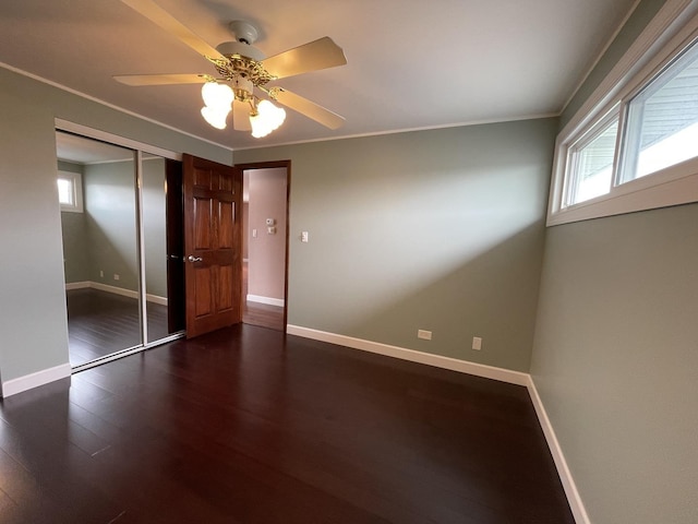 217 Kendrick Ct Unit 217, Schaumburg, IL 60194 - unfurnished bedroom featuring dark wood-style floors, a closet, crown molding, and ceiling fan