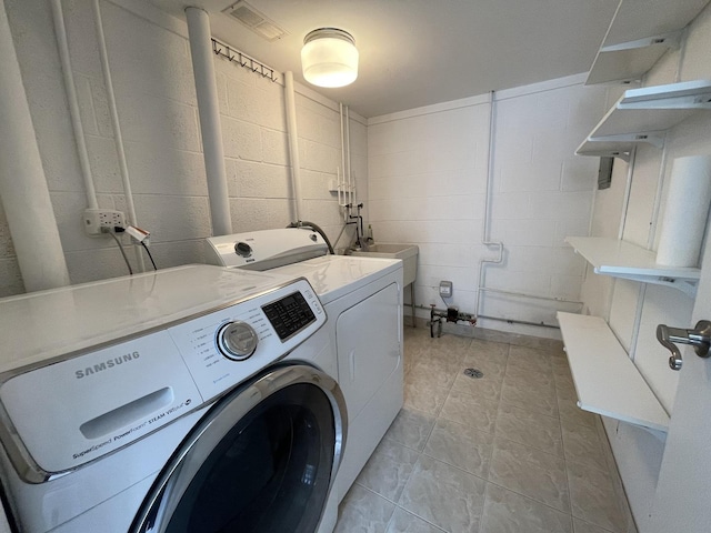 217 Kendrick Ct Unit 217, Schaumburg, IL 60194 - washroom with independent washer and dryer, concrete block wall, and light tile patterned floors
