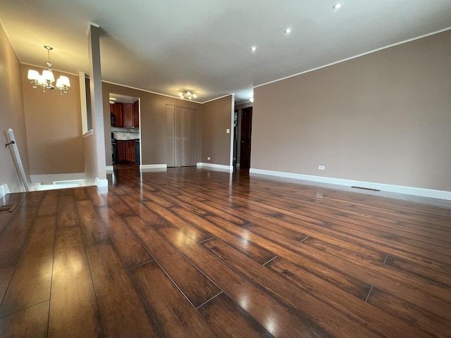 217 Kendrick Ct Unit 217, Schaumburg, IL 60194 - unfurnished living room featuring a chandelier, dark wood-style flooring, and ornamental molding