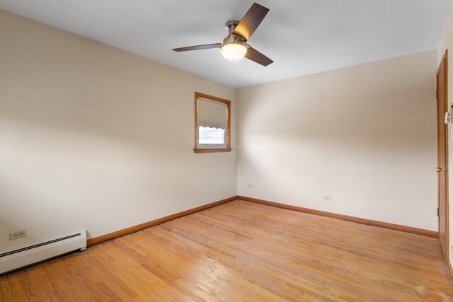 empty room with light hardwood / wood-style floors, a baseboard radiator, and ceiling fan