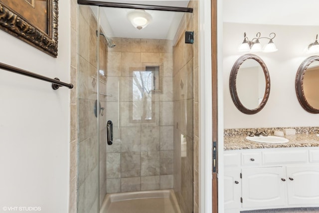 bathroom with vanity and a shower with shower door