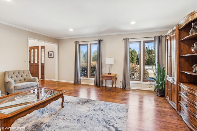 living room with plenty of natural light, dark hardwood / wood-style floors, and crown molding