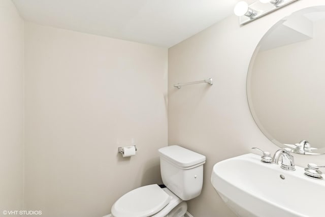 bathroom featuring sink and toilet