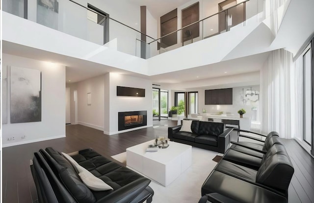 living room with a towering ceiling and light hardwood / wood-style floors