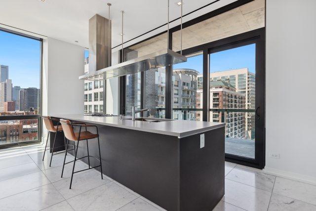 kitchen featuring a wall of windows and sink