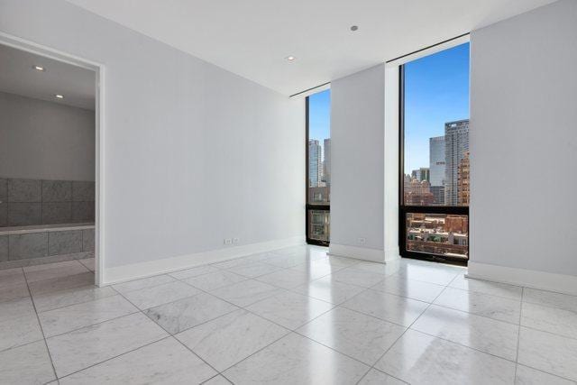 unfurnished room featuring floor to ceiling windows