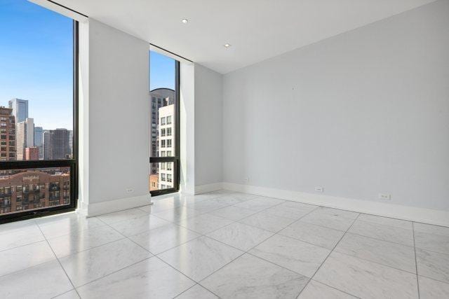 unfurnished room with expansive windows and a wealth of natural light