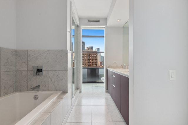 full bathroom featuring separate shower and tub, toilet, tile patterned flooring, and vanity