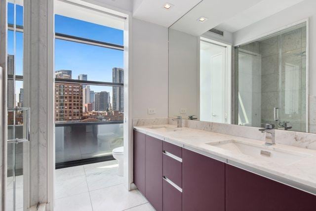 bathroom featuring toilet, an enclosed shower, tile patterned floors, and vanity