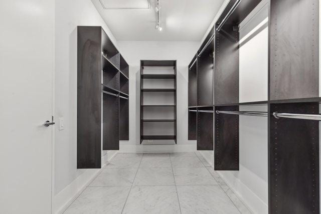 spacious closet with light tile patterned floors