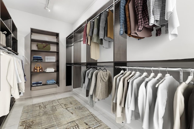 spacious closet with radiator heating unit and light tile patterned floors