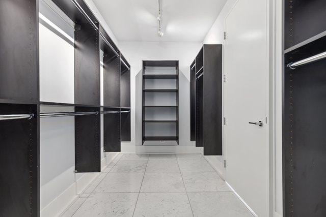 walk in closet with light tile patterned floors