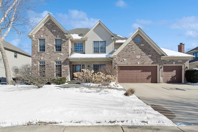 traditional-style home with driveway, brick siding, and an attached garage