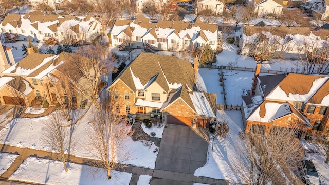 snowy aerial view featuring a residential view