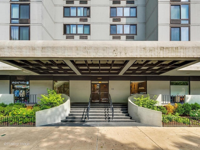 entrance to property featuring stucco siding