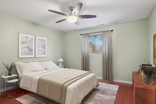 bedroom with dark wood-type flooring and ceiling fan