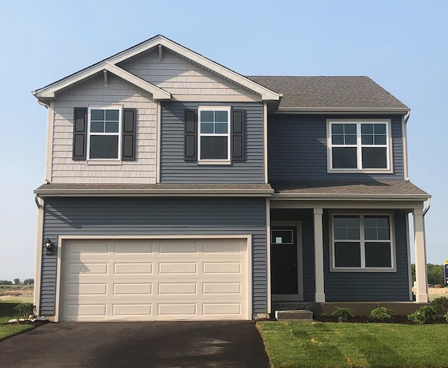 view of front facade featuring a garage and a front lawn