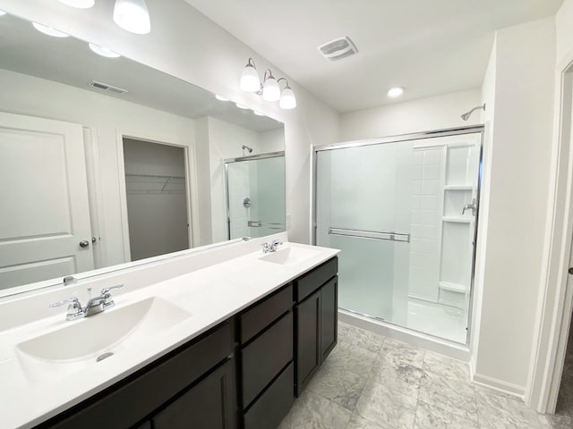 bathroom featuring vanity and a shower with shower door