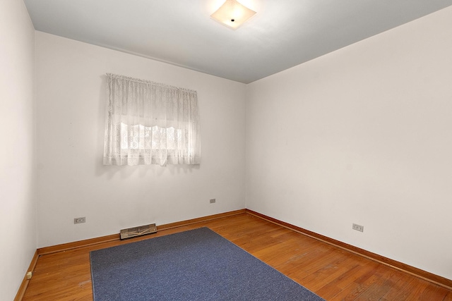 empty room featuring wood-type flooring