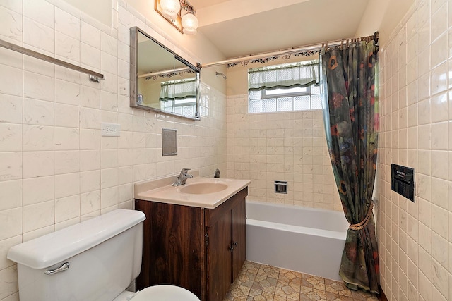 full bathroom with tile walls, tile patterned floors, vanity, and shower / bathtub combination with curtain