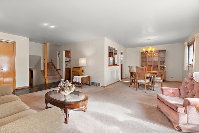 carpeted living room with a chandelier