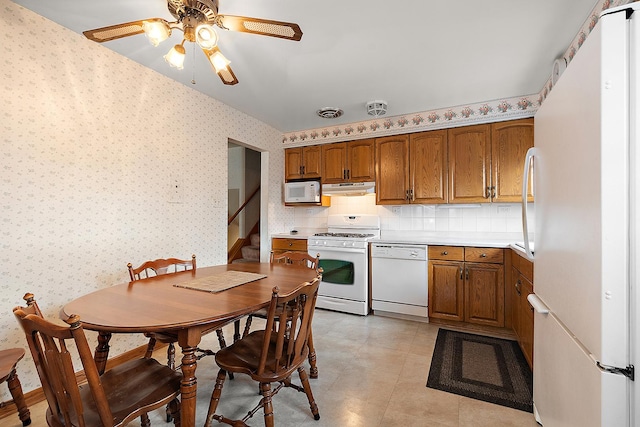 kitchen with ceiling fan, backsplash, and white appliances