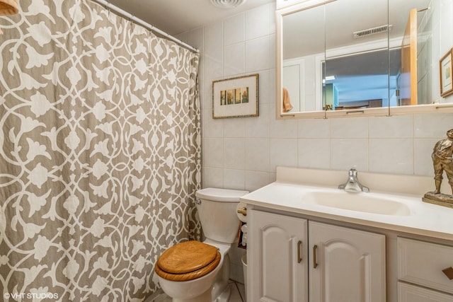 bathroom with vanity, tile walls, decorative backsplash, and toilet