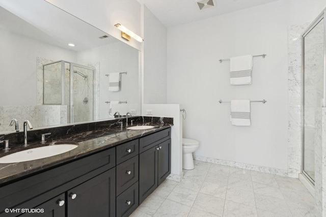 bathroom with vanity, toilet, and an enclosed shower