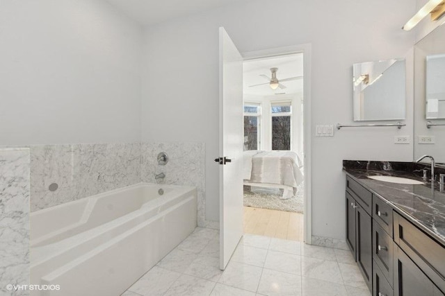 bathroom featuring a tub to relax in, tile patterned floors, and vanity