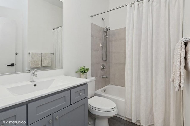 full bathroom with vanity, shower / bath combo, and toilet