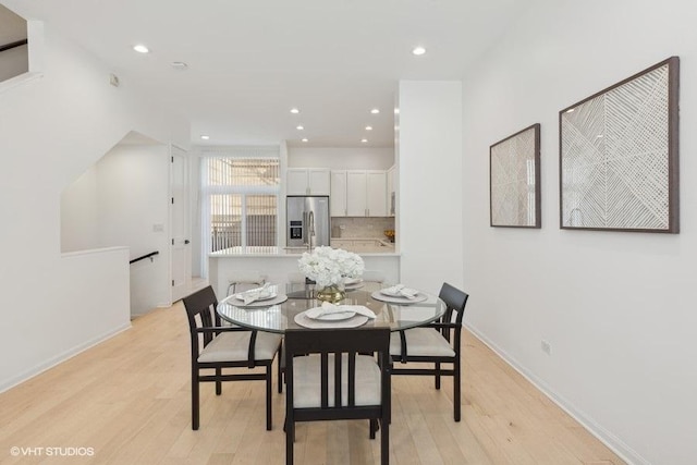 dining space with light hardwood / wood-style floors