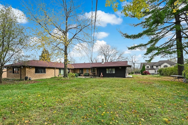 rear view of property with a yard