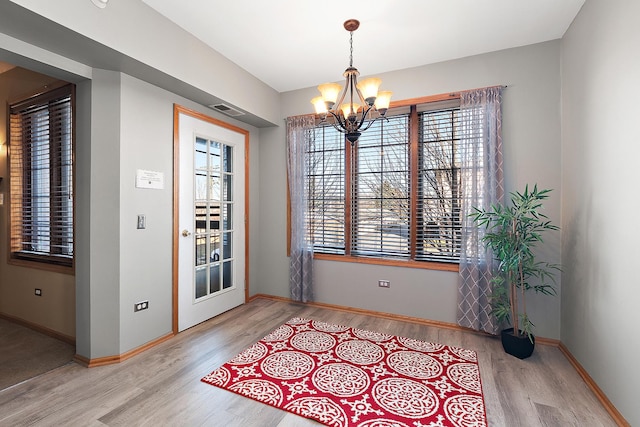 dining room featuring a chandelier and light hardwood / wood-style flooring