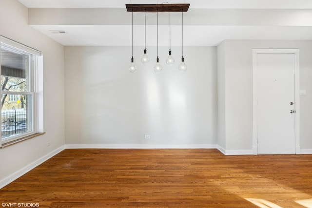 unfurnished dining area featuring hardwood / wood-style floors