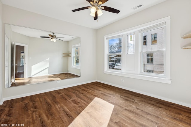 empty room with hardwood / wood-style flooring and ceiling fan