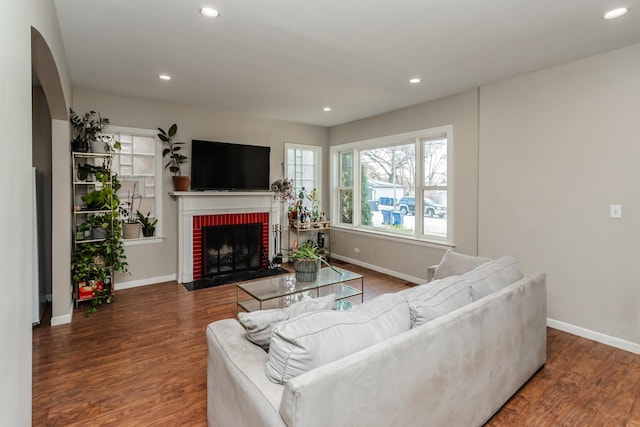 living room with hardwood / wood-style floors and a fireplace