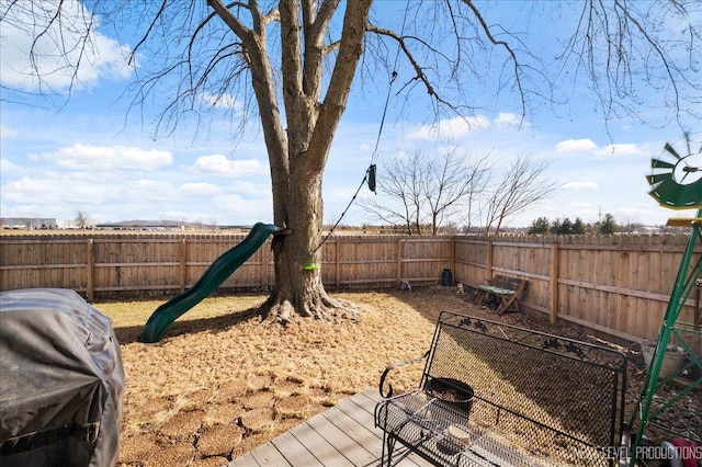 view of yard featuring a playground and a deck