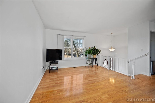 unfurnished living room with hardwood / wood-style floors