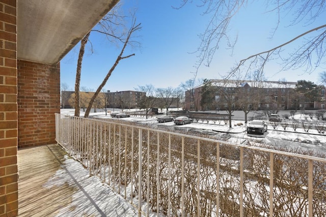 view of snow covered back of property