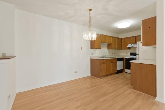 kitchen featuring sink, light hardwood / wood-style flooring, dishwasher, white range oven, and decorative light fixtures