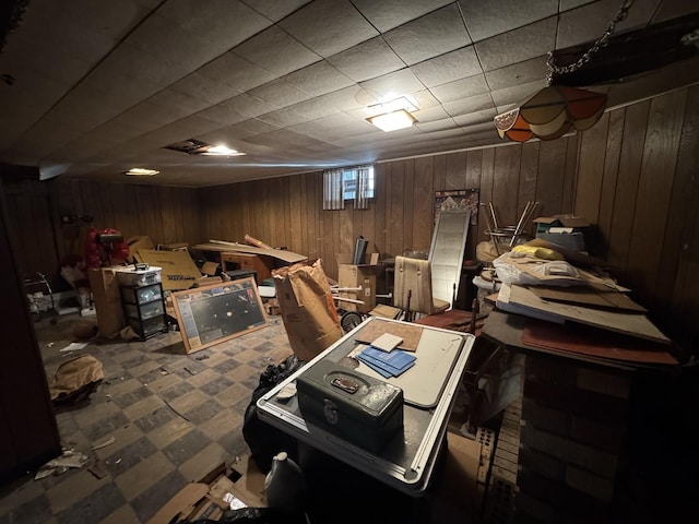 basement featuring wooden walls