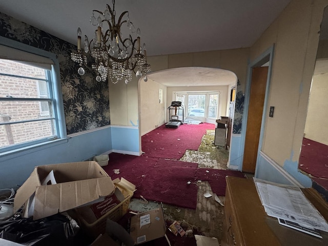 miscellaneous room featuring carpet floors and a notable chandelier