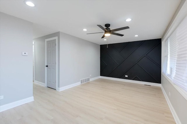 unfurnished room featuring ceiling fan and light wood-type flooring