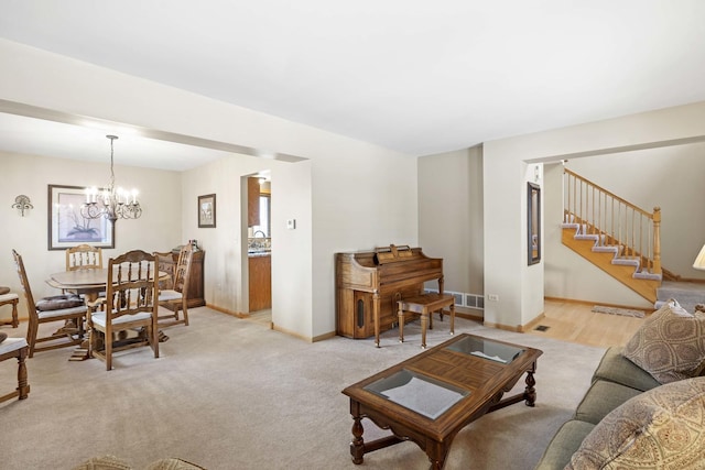 carpeted living room featuring an inviting chandelier