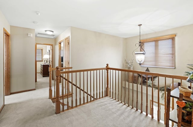 hallway featuring light colored carpet