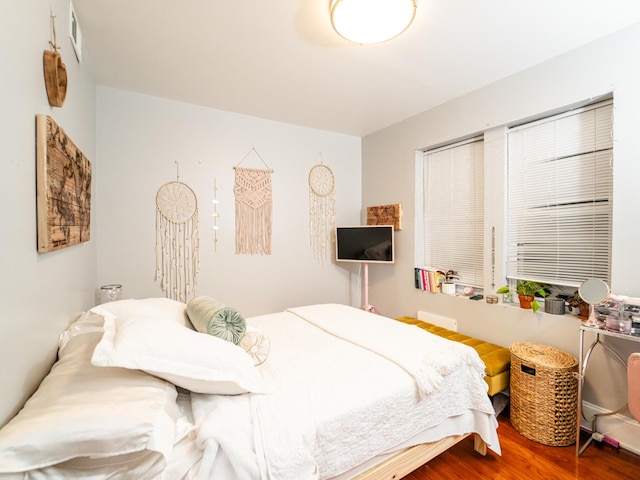 bedroom with hardwood / wood-style flooring