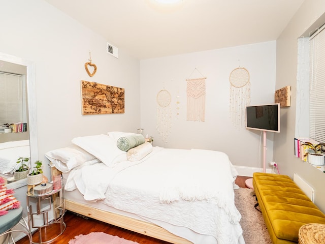 bedroom with hardwood / wood-style flooring