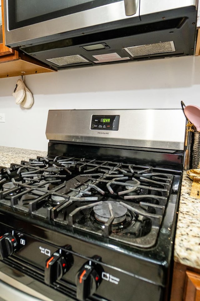 interior details featuring stainless steel appliances and light stone counters